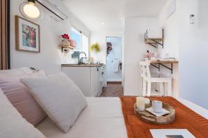 a living room with a white couch and a kitchen at Studio with Terrace & Stunning Views in Güéjar-Sierra