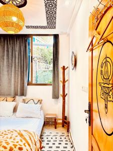 a bedroom with two beds and a window at Garden view double room in Agadir