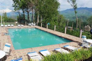a swimming pool with lounge chairs at Heavenly View - Bear Themed Cabin, HotTub, Dog-Friendly, Near Gatlinburg in Gatlinburg