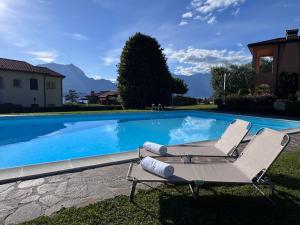 a pair of lounge chairs next to a swimming pool at Casa Donata by Gottschalk in Lierna