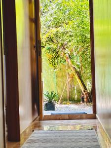 an open door with a view of a garden at Garden view double room in Agadir