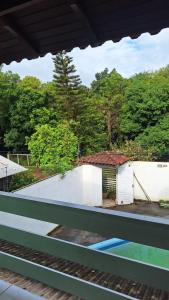 a train station with a white building and trees at Sítio do piu in Lombas