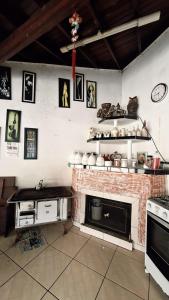 a kitchen with a stove and a brick fireplace at Sítio do piu in Lombas