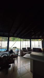 a room with chairs and a table and a pool at Sítio do piu in Lombas