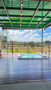 a swimming pool in a building with a view of a field at Casa de Chame Refúgio da Serra in Brasília