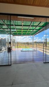 a large glass door with a view of a pool at Casa de Chame Refúgio da Serra in Brasília