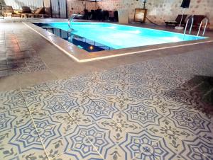 a swimming pool with a tile floor in a building at Aze's Garden suites - Kalkan, Kaş in Kaş +10 photos