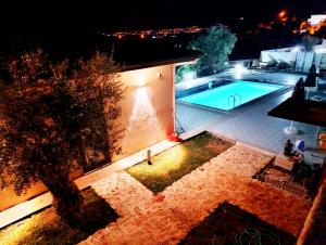 an overhead view of a swimming pool at night at Aze's Garden suites - Kalkan, Kaş in Kaş