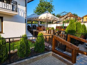 a balcony with a fence and a patio at Garden Lux Grujić Apartmani in Krivi Vir