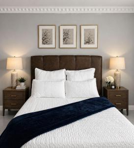 a bedroom with a large bed with two night stands at R&N Hosts in Maseru