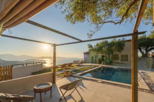 a villa with a pool and a view at Villa Maestoso in Mirsíni