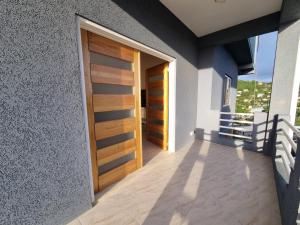 a hallway of a house with a wooden door at Sunset Apartment in Grand Anse +3 photos