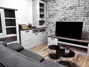 a living room with a couch and a flat screen tv at Villa Calhia in León