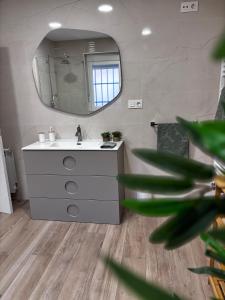 a bathroom with a sink and a mirror at Villa Calhia in León +14 photos