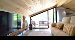 a living room with a couch and a large window at Puro Wild in Geres