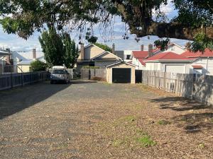a car parked in the driveway of a house at Armidale Central Guest House in Armidale