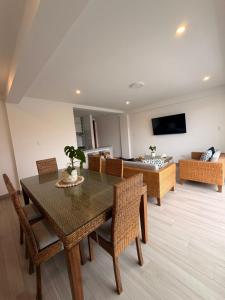 a living room with a table and chairs and a couch at Punta Hermosa Apartment in Punta Hermosa