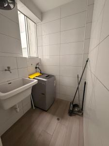 a bathroom with a sink and a trash can at Punta Hermosa Apartment in Punta Hermosa +7 photos