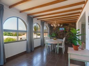 a dining room with a table and chairs and windows at Casa Zapato in La Pared