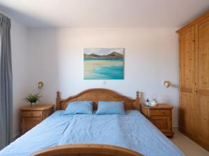 a bedroom with a blue bed with two night stands at Casa Zapato in La Pared