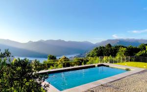 a swimming pool with a view of a lake and mountains at Puro Wild in Geres