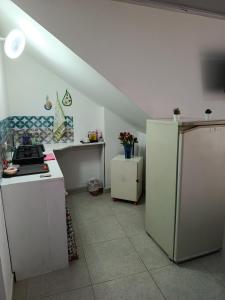 a kitchen with white cabinets and a refrigerator at Mi Rincón Feliz in Choachí +10 photos