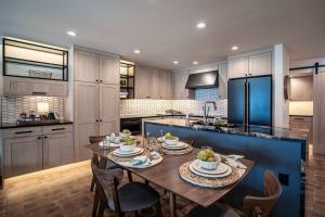 a kitchen with a wooden table with chairs and a blue refrigerator at Designer Lakefront Condo C1 Wapato Point Chelan in Manson