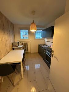 a kitchen with a table and a dining room at Monteurs Freund in Lotte