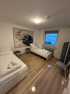 a room with two beds and a couch and a window at Monteurs Freund in Lotte