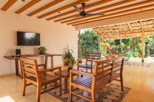 a dining room with a table and chairs at Casa Pakal Valladolid in Valladolid