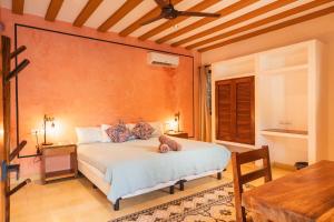 a bedroom with a bed and a table at Casa Pakal Valladolid in Valladolid +23 photos