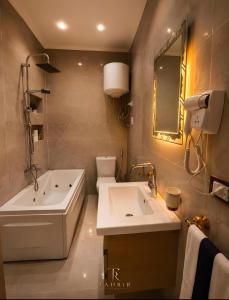 a bathroom with a tub and a toilet and a sink at Lumina View Hotel by Tahrir - Downtown in Cairo +66 photos