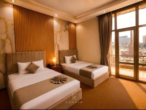a hotel room with two beds and a window at Lumina View Hotel by Tahrir - Downtown in Cairo