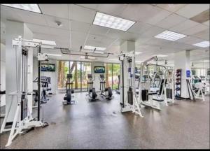 a gym with treadmills and machines in a room at Ocean Reserve Miami Sunny Isles Collins Ave in Sunny Isles Beach