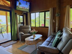 a living room with a couch and a table at Sigasiga Sands Boutique Bungalows in Savusavu