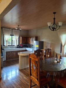 a kitchen with a table and a dining room at Finca La Concepción in Marcala