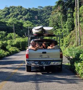 a group of people riding in the back of a truck at La Redonda Surf Hostel Sayulita in Sayulita +60 photos