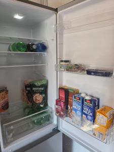 an open refrigerator filled with food and drinks at Acorn Creek Tented Camp in Nidda +42 photos