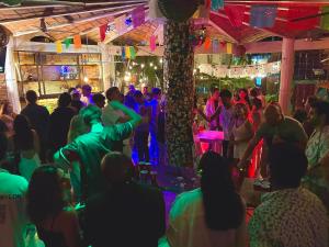 a crowd of people dancing at a party at La Redonda Surf Hostel Sayulita in Sayulita