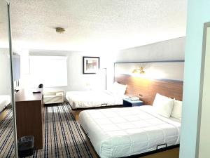 a hotel room with two beds in a room at AmericInn by Wyndham Frankfort IN in Frankfort