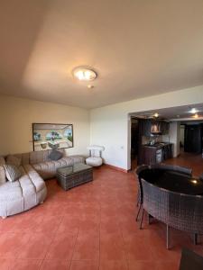 a living room with a couch and a table at 2BR Sea View Chalet Porto sokhna in Ain Sokhna