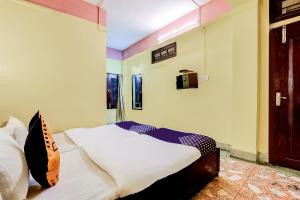 a bedroom with a bed and a tv on the wall at SPOT ON Durba 2 in Tezpur +39 photos