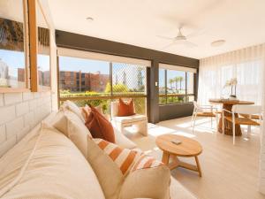 a living room with a couch and a table at Alex Headland Unit Views to the Ocean in Alexandra Headland