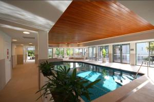 a swimming pool in a house with a wooden ceiling at The View in Lorne