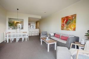 a living room with a couch and a table at The View in Lorne