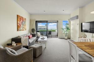 a living room with a couch and a table at The View in Lorne