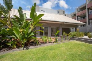 a house with a lawn in front of a building at The View in Lorne