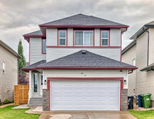 a house with a garage door in front of it at Rome, Sweet Home in Calgary