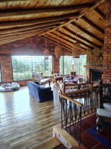 a large living room with wooden floors and brick walls at La Toscana, Chalet Campestre in Guasca