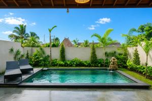 a swimming pool in the backyard of a villa at Akar Villa in Ubud